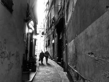 People walking on road amidst buildings