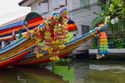 Multi colored boats in canal amidst buildings