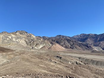 Scenic view of mountains against clear blue sky