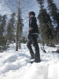 Full length of man standing on snow covered landscape