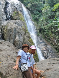 Rear view of woman looking at waterfall