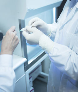 Doctors filling syringe in hospital