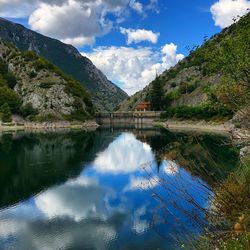 Scenic view of lake and mountains against sky