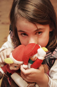 High angle portrait of girl with santa claus toys