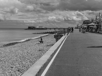 People on beach against sky