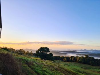 Scenic view of land against sky during sunset