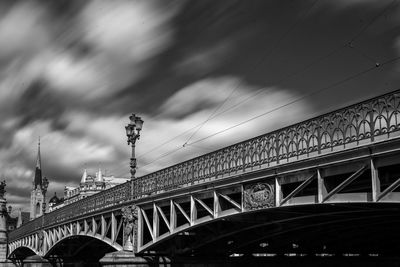 Low angle view of bridge against sky in city