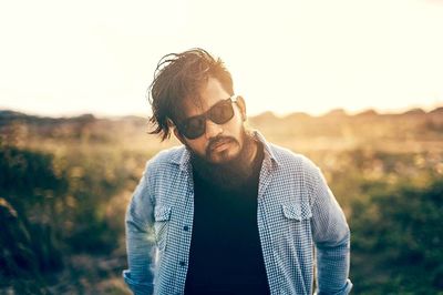 Young man wearing sunglasses standing outdoors