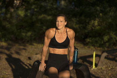 Smiling woman exercising outdoors