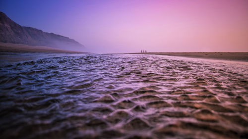 Scenic view of sea against clear sky during sunset