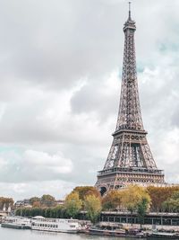 View of eiffel tower against cloudy sky