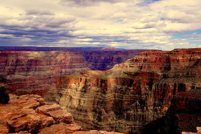 View of rock formations against cloudy sky