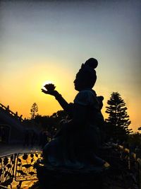 Silhouette of woman at sunset