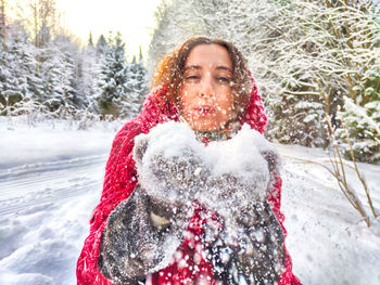 Portrait of smiling young woman in snow