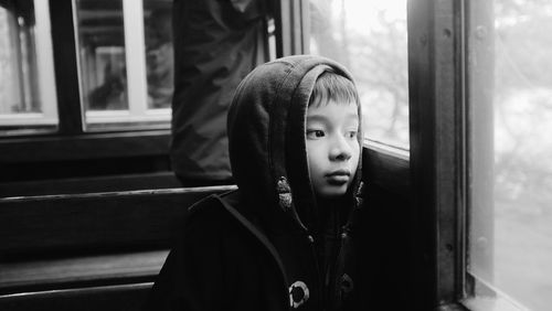 Portrait of boy looking through window