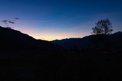 Scenic view of silhouette mountains against sky at sunset