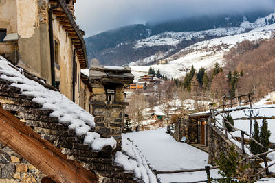 High angle view of snow covered buildings and mountains