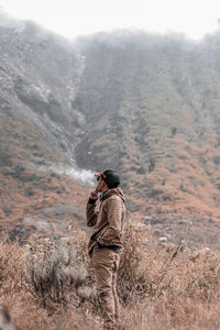 Rear view of man standing on land