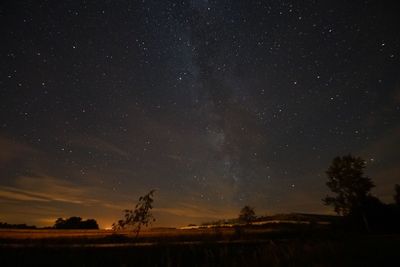 Scenic view of landscape against sky at night