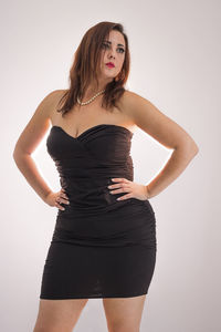 Portrait of woman standing against white background