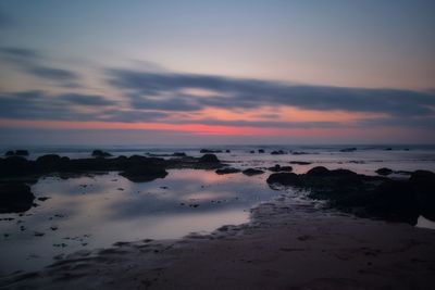 Scenic view of sea against cloudy sky