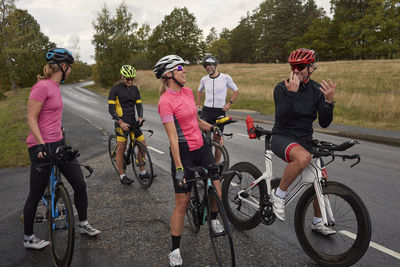 Cyclists relaxing on roadside