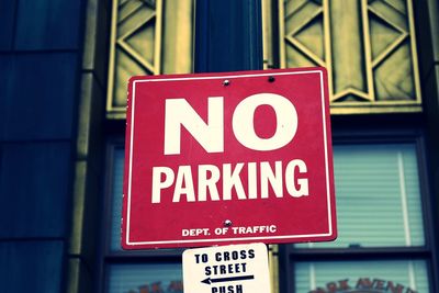 Low angle view of no parking sign outside building