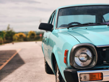 Close-up of car on road