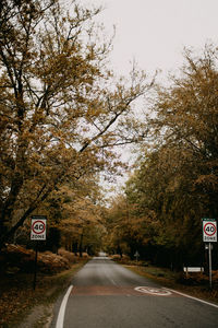 Road sign by trees