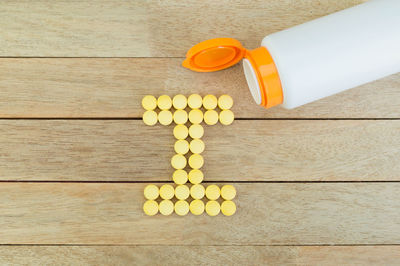 High angle view of yellow bottles on table