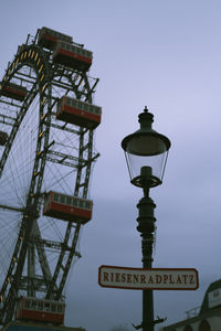 Low angle view of ferris wheel against sky