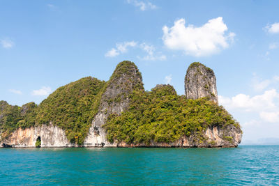 Scenic view of rocks in sea against sky