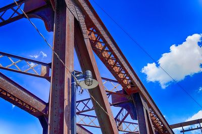 Low angle view of bridge against blue sky