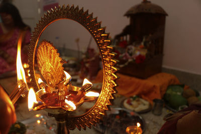 Puja set up in hinduism. selective focus on burning traditional brass lamp called diya .