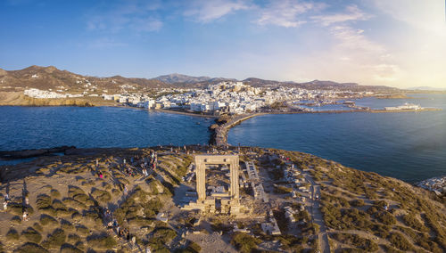 High angle view of townscape by sea against sky