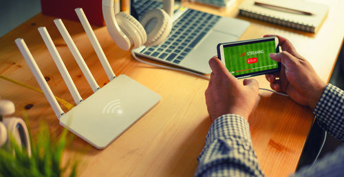 Midsection of man using laptop on table