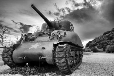 Tank against cloudy sky