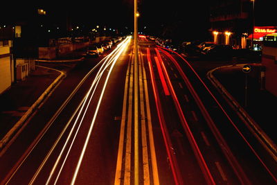 High angle view of light trails on road at night