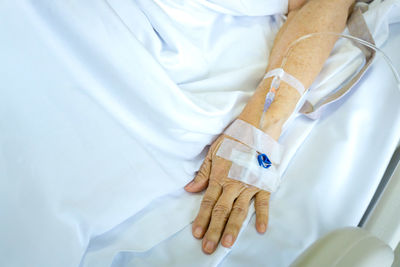 High angle view of man relaxing on bed