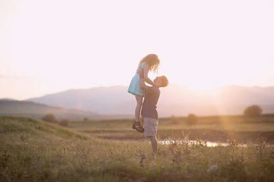 People standing on grassy field