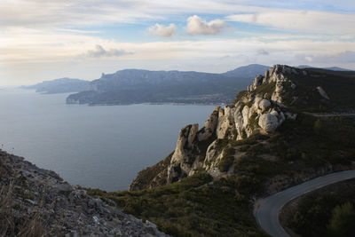 Scenic view of sea and mountains against sky