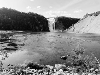 Scenic view of waterfall against sky