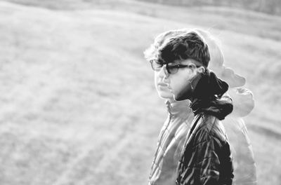Young man looking away on field