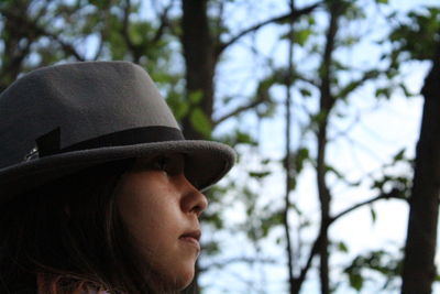 Close-up of young woman wearing hat