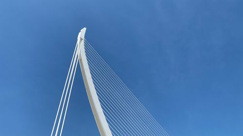 Low angle view of bridge against clear blue sky