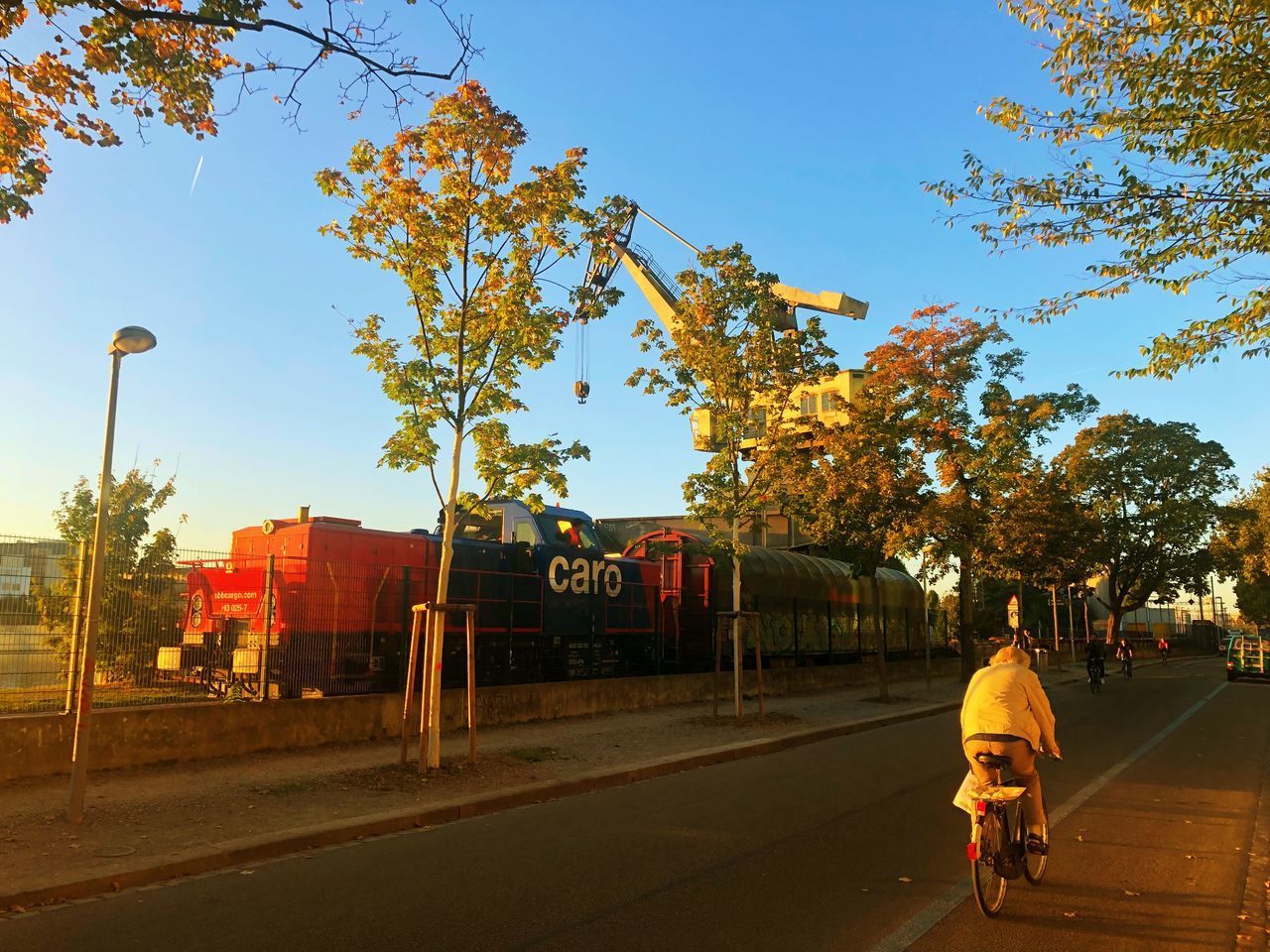 REAR VIEW OF MAN WALKING ON STREET