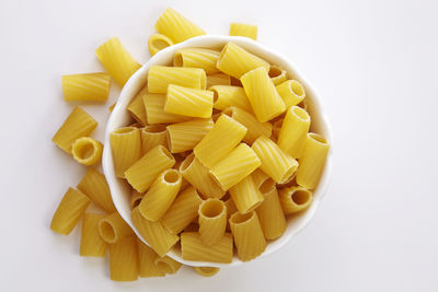 Close-up of pasta in bowl against white background