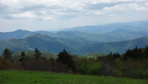 Scenic view of landscape and mountains against sky