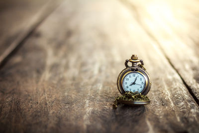 Close-up of pocket watch on table