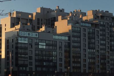 Buildings in city against clear sky